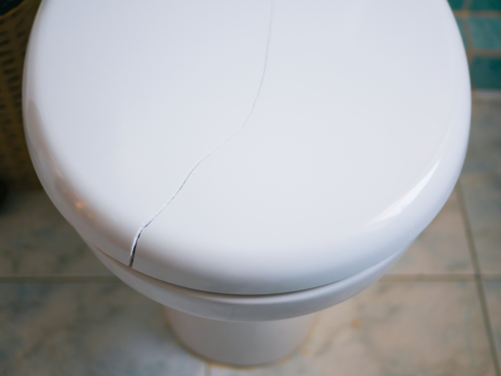 lid of toilet with a crack in it