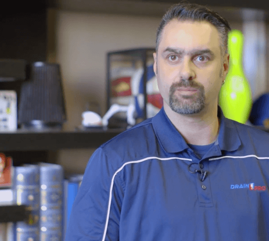 Drain Pro Plumber looks at the camera before answering a question for a video interview.