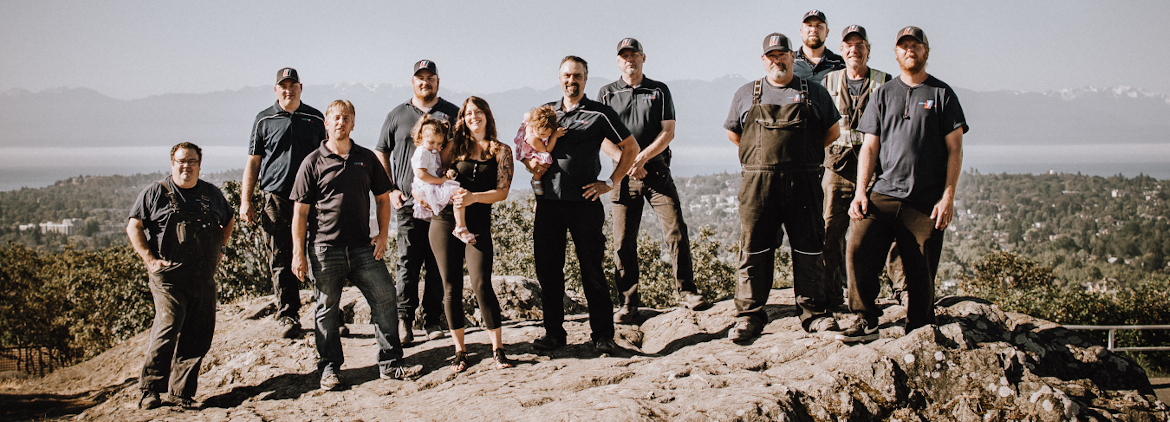 Drain Pro Plumbing Team standing on a rock overlooking Victoria, British Columbia