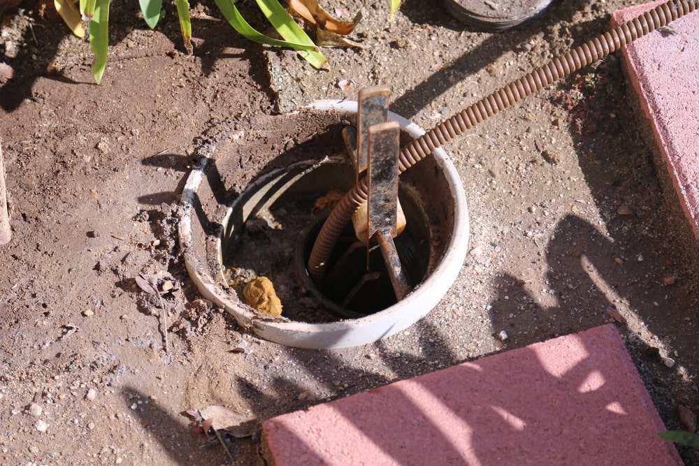 a plumbing technician working on a drainage system without using drain excavation